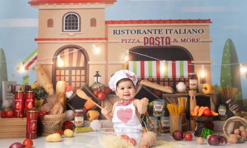 Newborn Photography Blog | Blossom Brook Studio 589 Adorable baby dressed as a little chef playing with spaghetti during a Baby Chef Photoshoot in Sydney at Blossom Brook Studio.