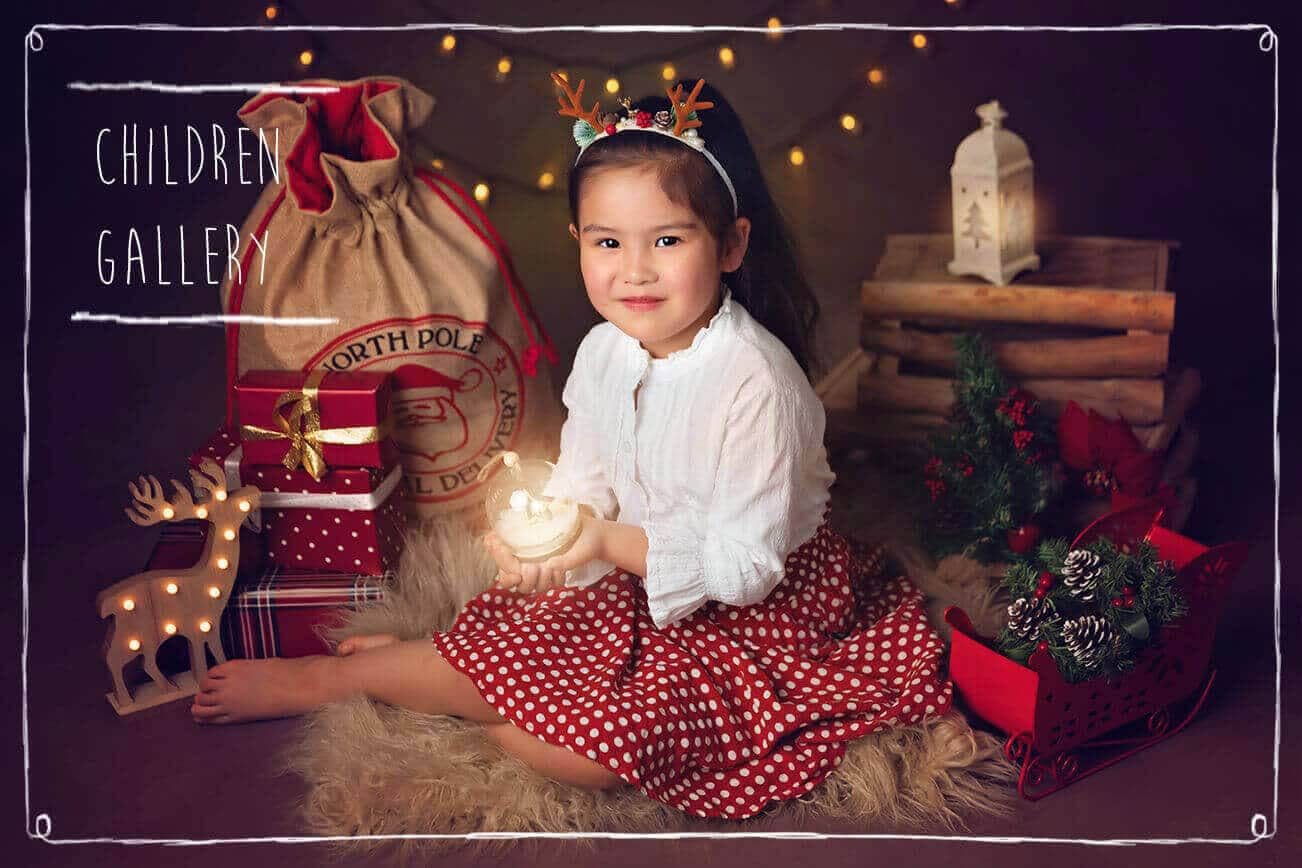 A girl holding a Lantern with Christmas props around