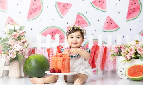 Newborn Photography Blog | Blossom Brook Studio 594 Adorable 10-month-old baby girl enjoying a watermelon-themed photoshoot in Sydney with summer fruits, flowers, and bright, cheerful décor, captured by Blossom Brook Studio.