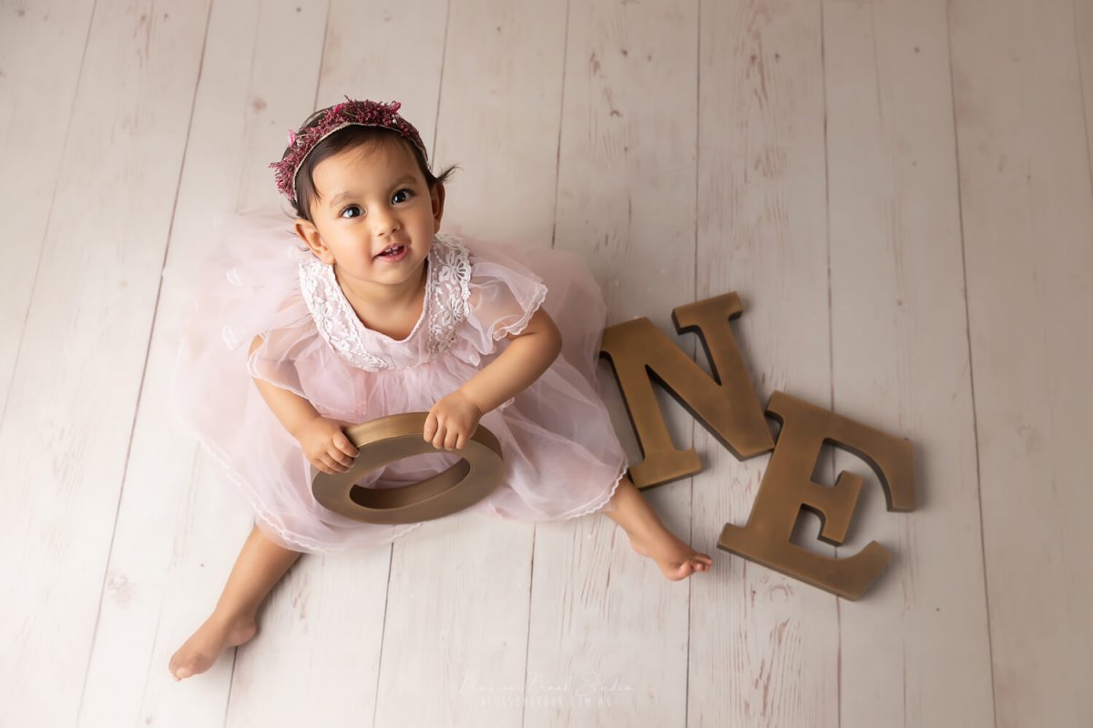 baby one year old photoshoot in sydney baby girl pink wooden floor