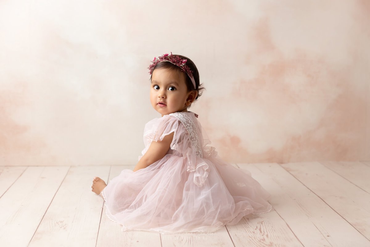 baby photoshoot in sydney baby girl pink wooden floor