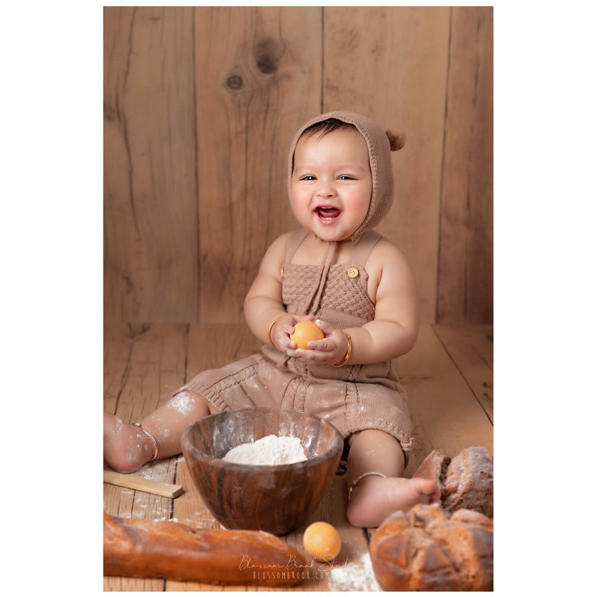 baby photoshoot in sydney baby boy in bear costume on wooden floor