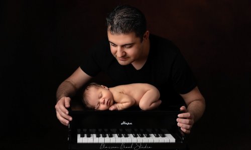 newborn baby photo with piano and dad