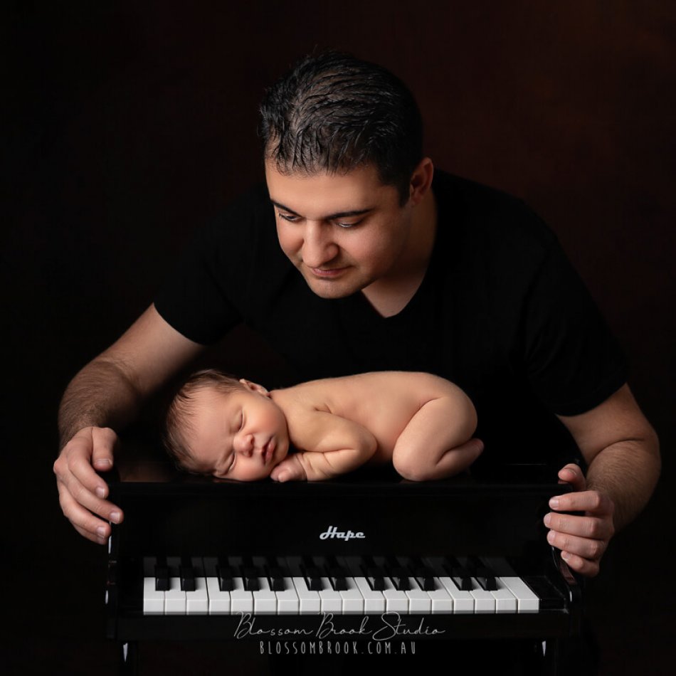 newborn baby photo with piano and dad