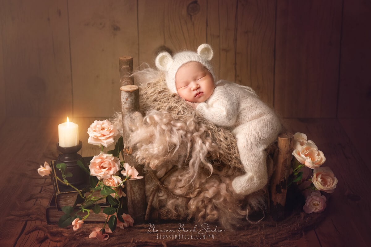 newborn photography baby lie on bed in bear costume